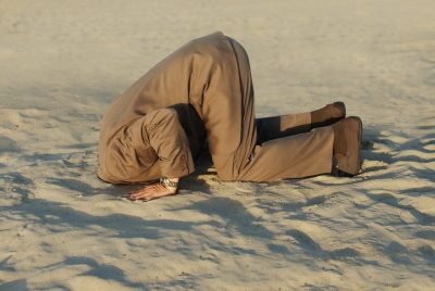 Business,Man,With,His,Head,Buried,In,The,Sand business man with his head buried in the sand